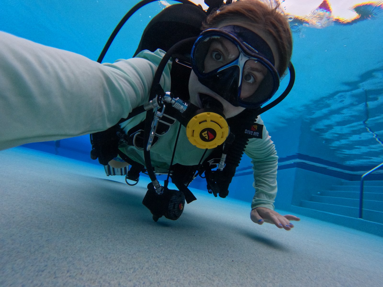 My daughter, a Divemaster candidate, swimming along the bottom of the pool in full scuba gear